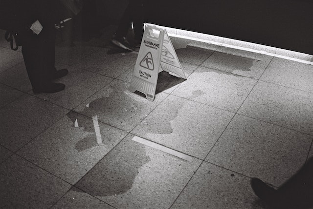 wet floor sign next to puddle