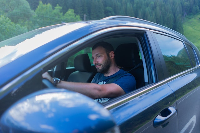 man driving sedan