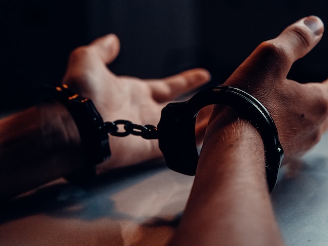 suspect with hand cuffs on